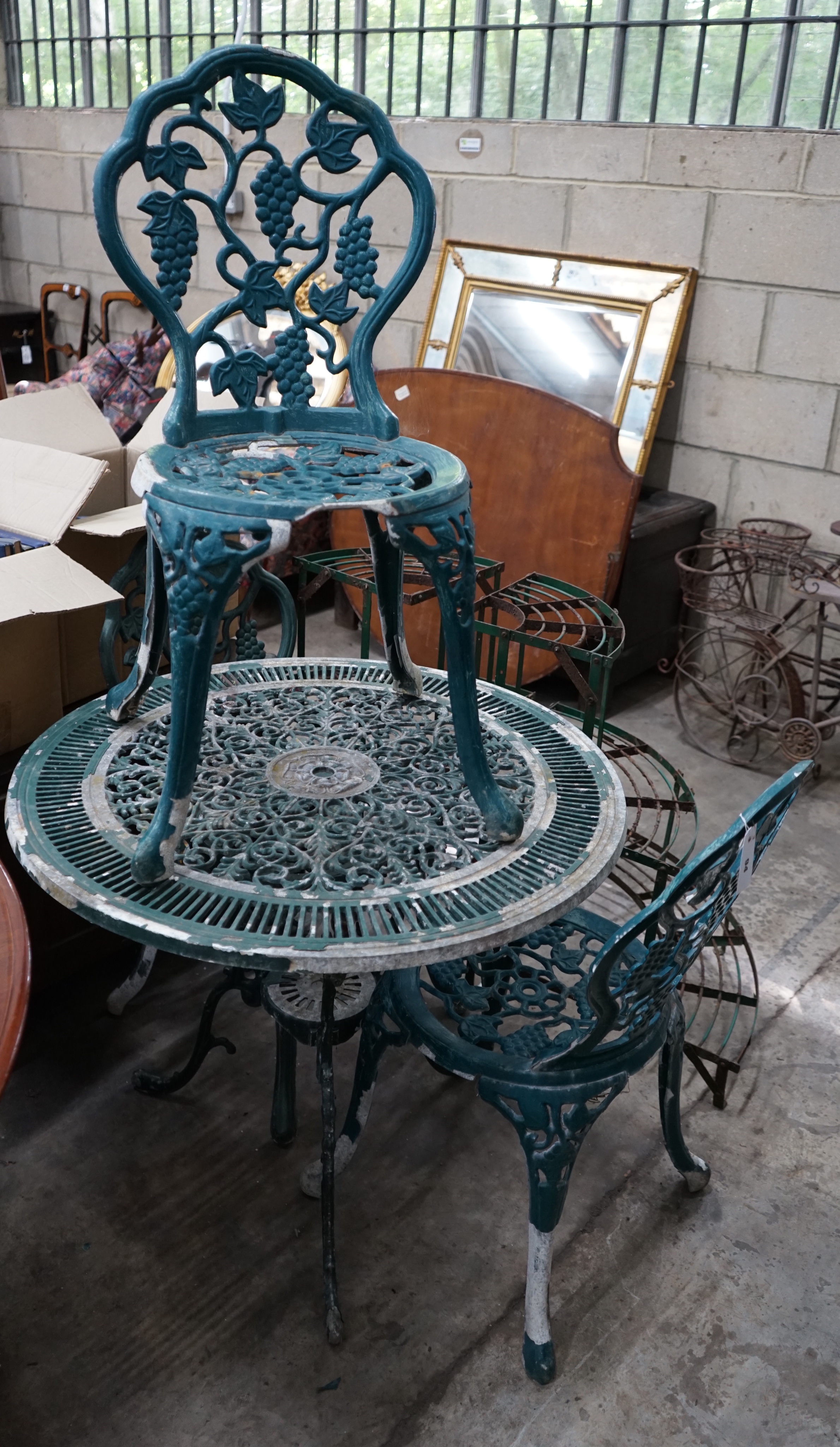 A circular painted aluminium garden table and three chairs, table diameter 79cm height 67cm